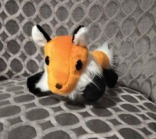 A front view of a chibi fox plush