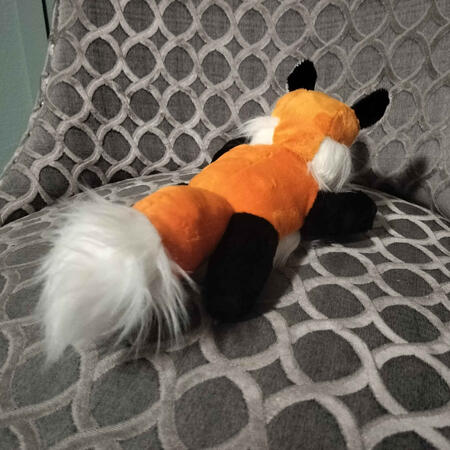 A back view of a chibi fox plush