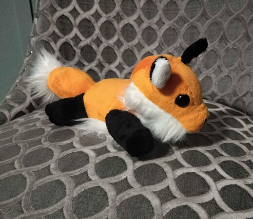 A three quarter view of a chibi fox plush